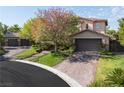 Elegant two-story home with a three-car garage and a meticulously landscaped front yard at 2285 Villefort Ct, Las Vegas, NV 89117