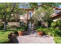 Inviting home entrance with double glass doors, stone accents, and lush greenery at 2285 Villefort Ct, Las Vegas, NV 89117