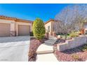 Charming home featuring desert landscaping and a three-car garage at 2357 Wisconsin Dells Dr, Henderson, NV 89044