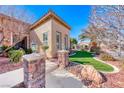 Charming home featuring a well-manicured front yard with stone accents and artificial turf at 2357 Wisconsin Dells Dr, Henderson, NV 89044