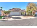 Well-kept single-story home with a tidy front yard, two-car garage, and durable tile roofing at 2459 Avenida Cataluna, Henderson, NV 89074