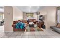 Cozy living room with neutral walls, tile floors, and comfortable seating at 2526 Begonia Valley Ave, Henderson, NV 89074