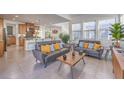 Open-concept living room showcasing modern furnishings, tile floors, and seamless flow to the kitchen at 2641 Via Monet, Henderson, NV 89044