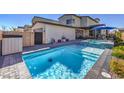 Backyard pool and spa with tiled accents, a patio area, and privacy fencing at 2641 Via Monet, Henderson, NV 89044