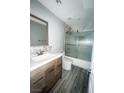 Well-lit bathroom features a modern vanity, large mirror and a glass shower door at 2720 Beaver Creek Ct # 202, Las Vegas, NV 89117