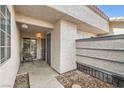 Cozy covered entryway featuring seating area and secure gated door with textured walls at 275 N Lamb Blvd # E, Las Vegas, NV 89110