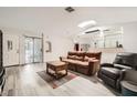 Bright living room with sliding glass doors, modern flooring, and an open floor plan to the kitchen at 275 N Lamb Blvd # E, Las Vegas, NV 89110