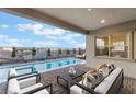 Relaxing covered patio with outdoor furniture overlooking a sparkling swimming pool at 350 Robledo St, Las Vegas, NV 89138