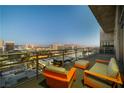 Relaxing balcony with comfortable seating and panoramic views of the city skyline at dusk at 353 E Bonneville Ave # 1407, Las Vegas, NV 89101