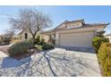 Inviting home exterior with a well-manicured yard, mature trees, and ample driveway space at 3805 Sorrowing Sparrow Ct, North Las Vegas, NV 89032