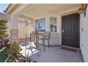 Cozy covered front porch with seating area and security door at 3805 Sorrowing Sparrow Ct, North Las Vegas, NV 89032