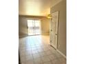 Sunlit living area featuring tile floors and sliding glass doors to the private balcony at 4965 Indian River Dr # 101, Las Vegas, NV 89103