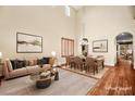 Bright, staged living room with high ceilings, hardwood floors, and elegant furniture at 505 Los Dolces St, Las Vegas, NV 89138