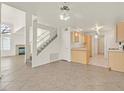 A bright living area showcasing a staircase, fireplace, and tile floors for modern comfort at 510 Crumpler Pl, Henderson, NV 89052