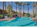 Community pool area with lounge chairs and tropical landscaping at 524 Turtleback Rd # A, Mesquite, NV 89027