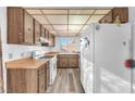 Functional kitchen featuring wood cabinetry, laminate countertops, and ample natural light at 5640 Vasila Dr, Las Vegas, NV 89110