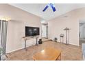 Bright living room with neutral walls, tile flooring, and a ceiling fan for added comfort at 5640 Vasila Dr, Las Vegas, NV 89110