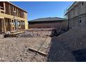 New construction home site showcasing the foundation and early building stages under a clear blue sky at 6616 Bowery St, Las Vegas, NV 89148