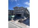 New construction home featuring a garage, scaffolding, and construction materials in the front yard at 6616 Bowery St, Las Vegas, NV 89148