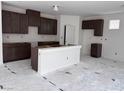 Spacious kitchen with dark wood cabinets, a white island, and plenty of counter space at 6616 Bowery St, Las Vegas, NV 89148