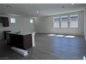 Bright living room with wood-look flooring and many windows at 6616 Bowery St, Las Vegas, NV 89148