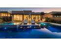 Backyard pool with lounge chairs and lush landscaping, perfect for outdoor entertaining and relaxation at 678 Blackrock Rim Dr, Henderson, NV 89012