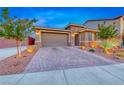 Beautiful home exterior with a brick driveway, well-maintained lawn, and inviting entrance at 7106 Stanley Frederick St, Las Vegas, NV 89166