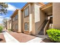 Attractive condo exterior featuring a walkway and staircase under covered area at 7300 Pirates Cove Rd # 1062, Las Vegas, NV 89145