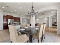 Bright dining room featuring a modern chandelier, stylish table setting, and easy access to the kitchen at 75 Luce Del Sole # 3, Henderson, NV 89011