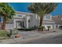 Well-maintained two-story home with desert landscaping and a three-car garage at 7650 Hartwell Dr, Las Vegas, NV 89123