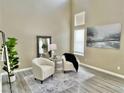 Bright living room with neutral colors, accent chairs, and modern decor at 7752 Orchard Wood Ct, Las Vegas, NV 89131