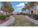 Well-maintained community park with lush landscaping, a playground, and walking paths at 7970 Calito St, Las Vegas, NV 89166