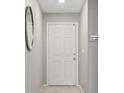 Clean entryway with neutral walls, a white door, and a decorative mirror at 7970 Calito St, Las Vegas, NV 89166