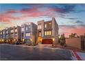 Modern townhomes feature neutral tones, a rooftop deck, two-car garages, and well-maintained landscaping in a tidy row at 8012 Carpenter Creek Ave, Las Vegas, NV 89113