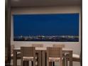 Dining area with stunning panoramic views of the city skyline at night at 826 Willits St, Las Vegas, NV 89138