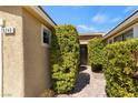 Inviting home entrance with desert landscaping and a brick pathway to front door at 9240 Northfield Park Ct, Las Vegas, NV 89148