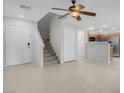 Open-concept living room with tile flooring, ceiling fan, and access to the kitchen at 9278 Hainsworth Ave, Las Vegas, NV 89148