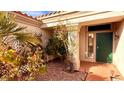 Charming front porch with decorative plants and a view of the home's exterior at 10528 Cogswell Ave, Las Vegas, NV 89134