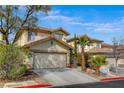 Inviting two-story home featuring desert landscaping, mature trees, and an attached two-car garage at 1209 Padre Serra Ln, Las Vegas, NV 89134