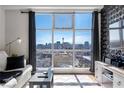 Bright living room featuring a large window showcasing the Las Vegas skyline and modern furnishings at 150 Las Vegas Blvd # 1608, Las Vegas, NV 89101