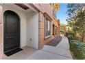 Elegant front door, stone detailing, with a landscaped walkway showcasing the home's curb appeal at 16 Via Visione # 101, Henderson, NV 89011