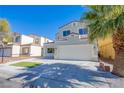 Lovely home showcasing a manicured lawn, mature trees, and a convenient two-car garage at 2032 Jesse Scott St, Las Vegas, NV 89106