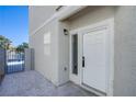 Inviting front entrance with a white door, side window, and a gravel walkway for easy access at 2032 Jesse Scott St, Las Vegas, NV 89106