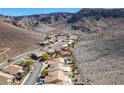 View of a neighborhood set in a desert landscape at the foot of a mountain range at 2035 King Mesa Dr, Henderson, NV 89012