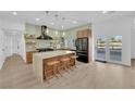 Modern kitchen with stainless steel appliances, granite countertop island, and decorative pendant lighting at 2160 Pueblo Cir, Las Vegas, NV 89169