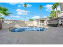 Inviting backyard pool with lounge chairs, spa, and surrounding palm trees for a serene escape at 2160 Pueblo Cir, Las Vegas, NV 89169