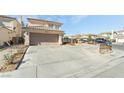 Inviting two-story home with neutral paint, a spacious driveway, and a two car garage at 2291 Grannis Ln, Las Vegas, NV 89104