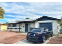 Single-story home with a well-kept front yard and a car parked outside the attached garage at 2609 Sierra Madre Dr, Las Vegas, NV 89102