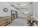 Bright kitchen featuring white cabinets, stainless steel appliances, and a skylight at 2728 Goldcreek St, Henderson, NV 89052