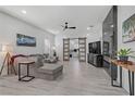 Bright living room with modern decor, gray sofa, and a statement fireplace with white walls at 2728 Goldcreek St, Henderson, NV 89052